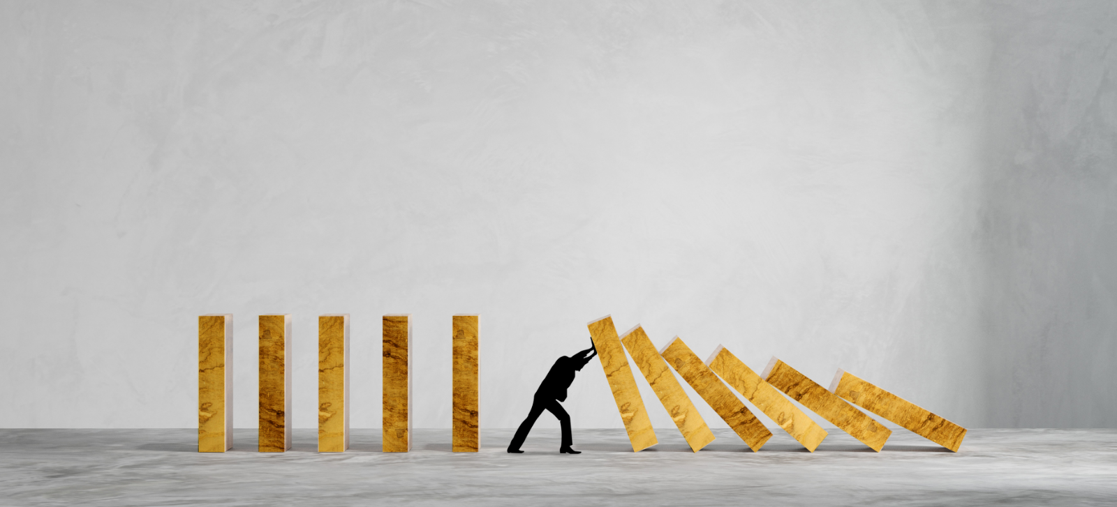 silhouette-man-panic-against-collapsing-wooden-dominos-business-crisis-failure-concept-wide-view